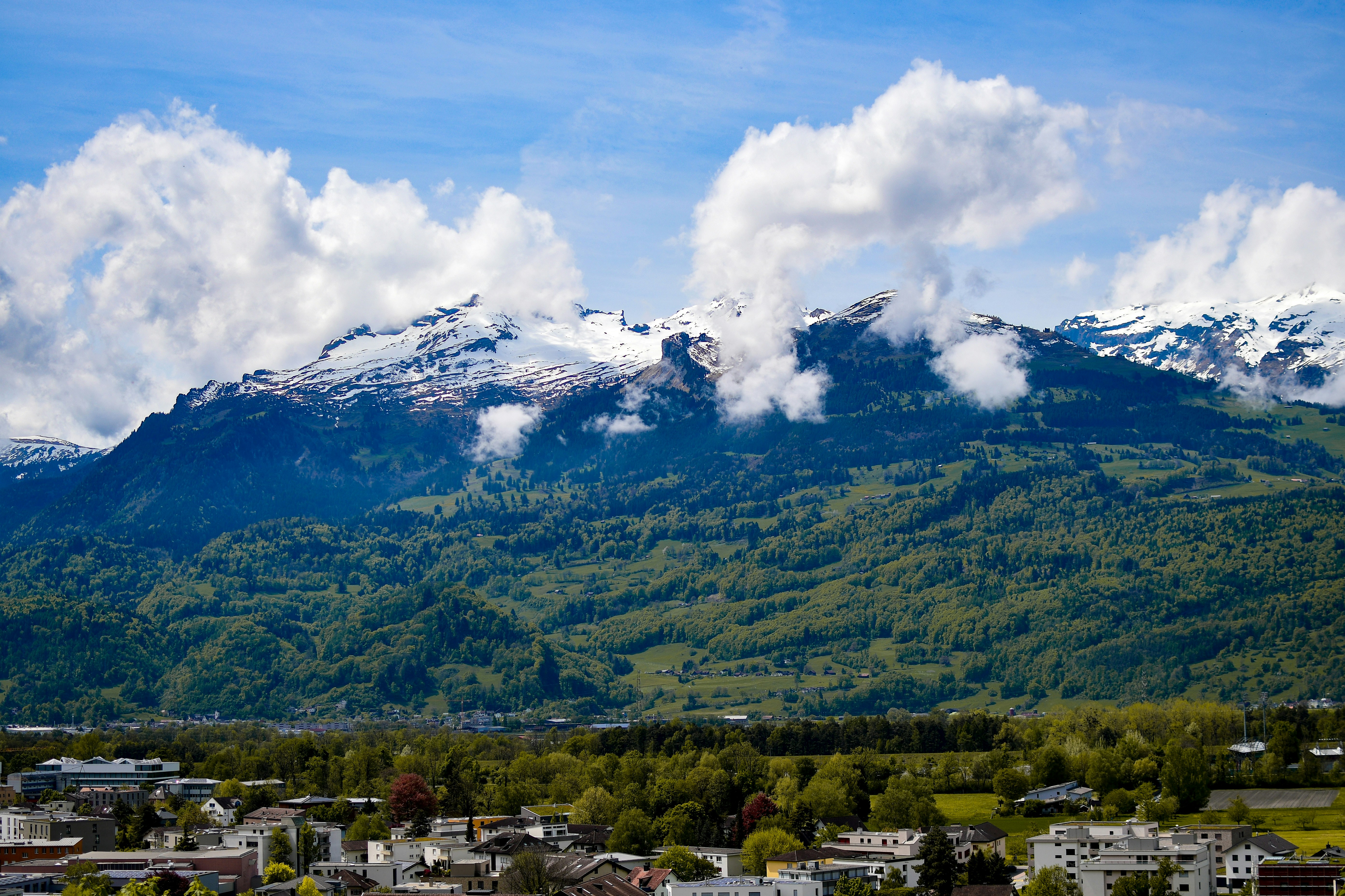 a view of a city with a mountain in the background, 