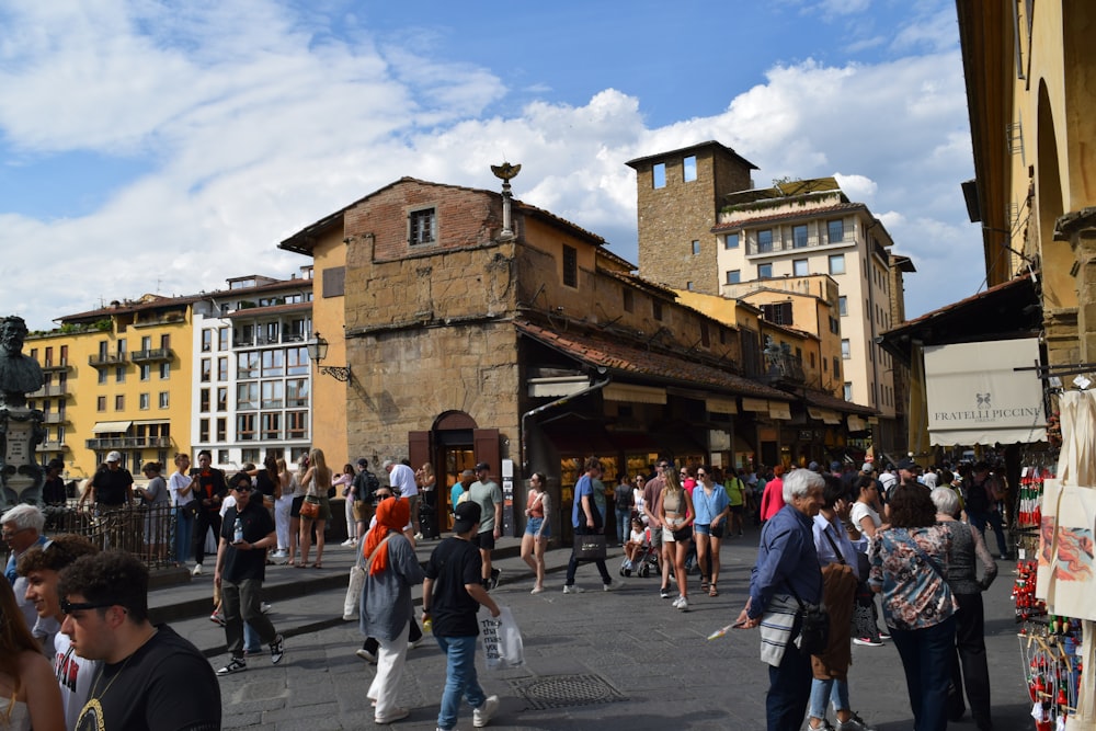 a crowd of people walking around a city street