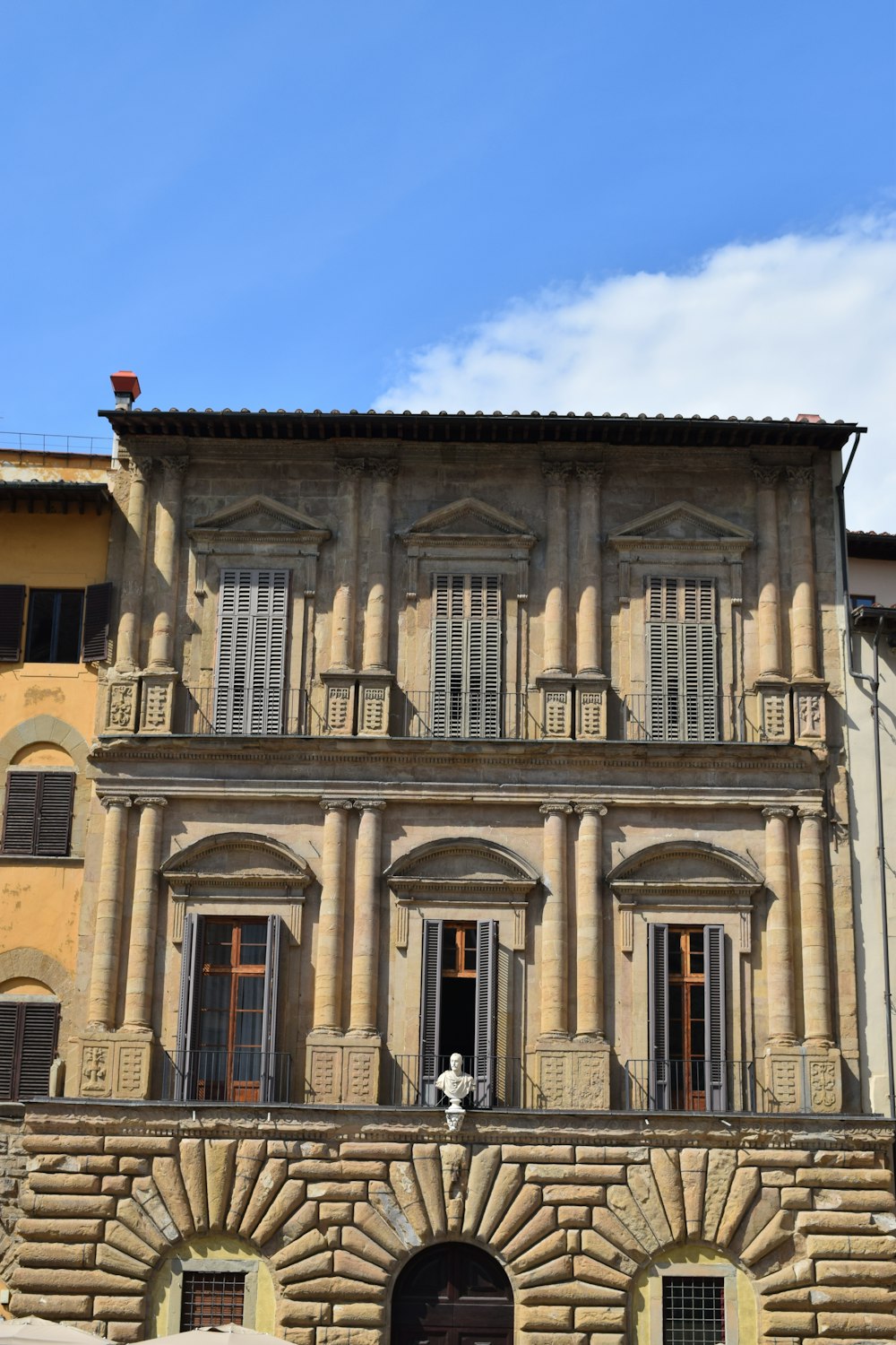 an old building with a clock on the front of it