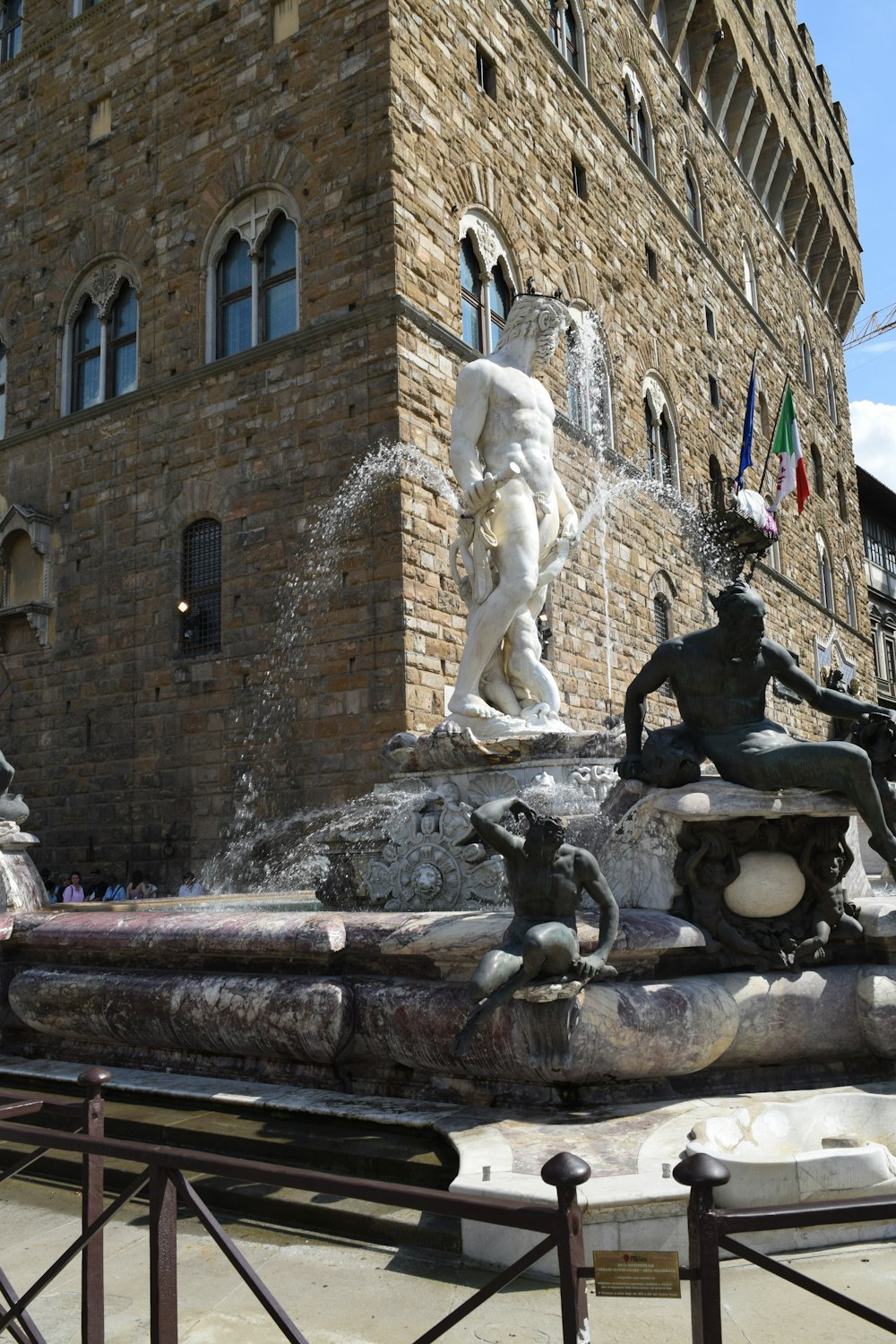 a fountain in front of a brick building