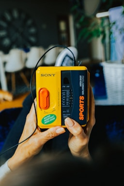 a person holding a yellow and black game controller
