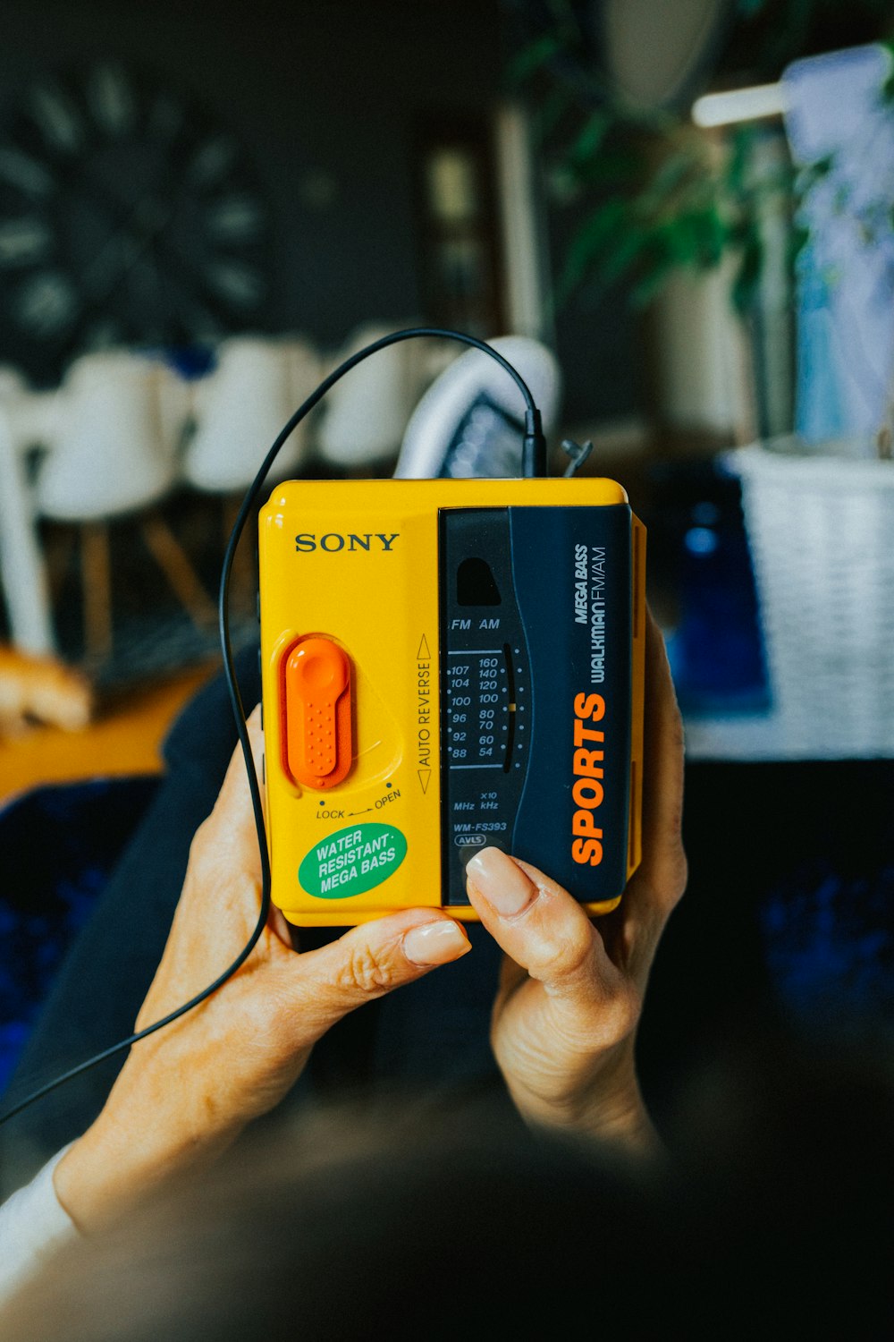 a person holding a yellow and black game controller