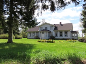 A cozy Michigan rental home with a neat lawn under a clear blue sky.