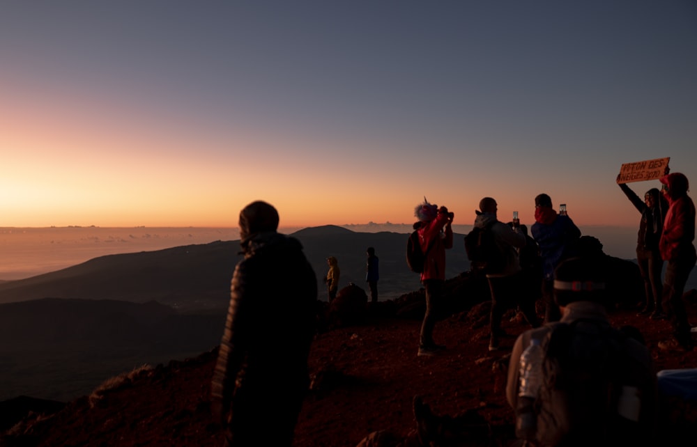 a group of people standing on top of a mountain