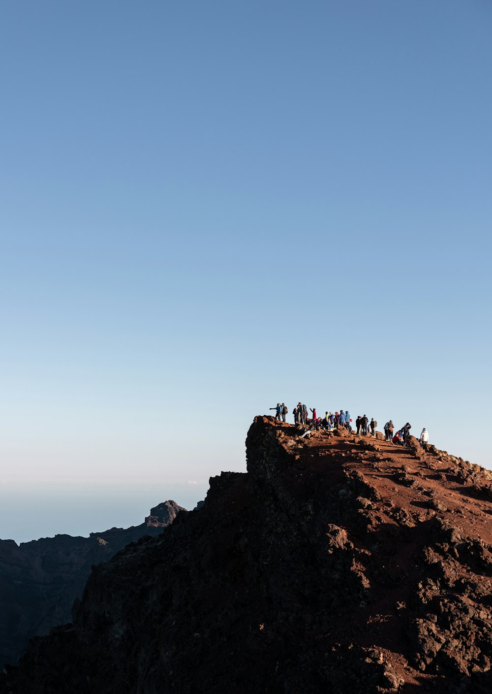 a group of people standing on top of a mountain