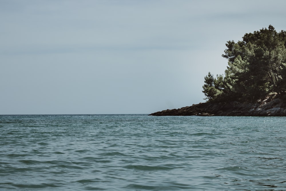 a large body of water with a small island in the background