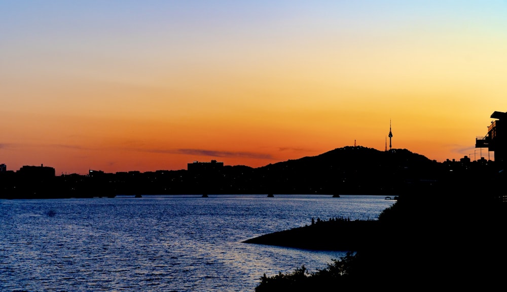 a body of water with a city in the background