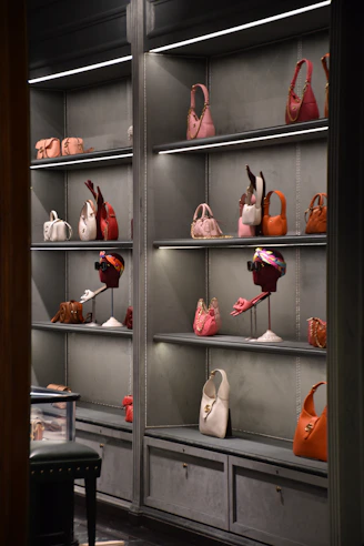 Close-up of elegant women's handbags arranged on a sleek modern shelf.