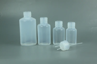 A selection of clear and tinted plastic bottles displayed on a white surface
