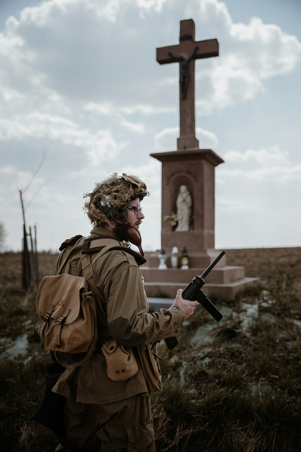 a person with a backpack and a cross in the background