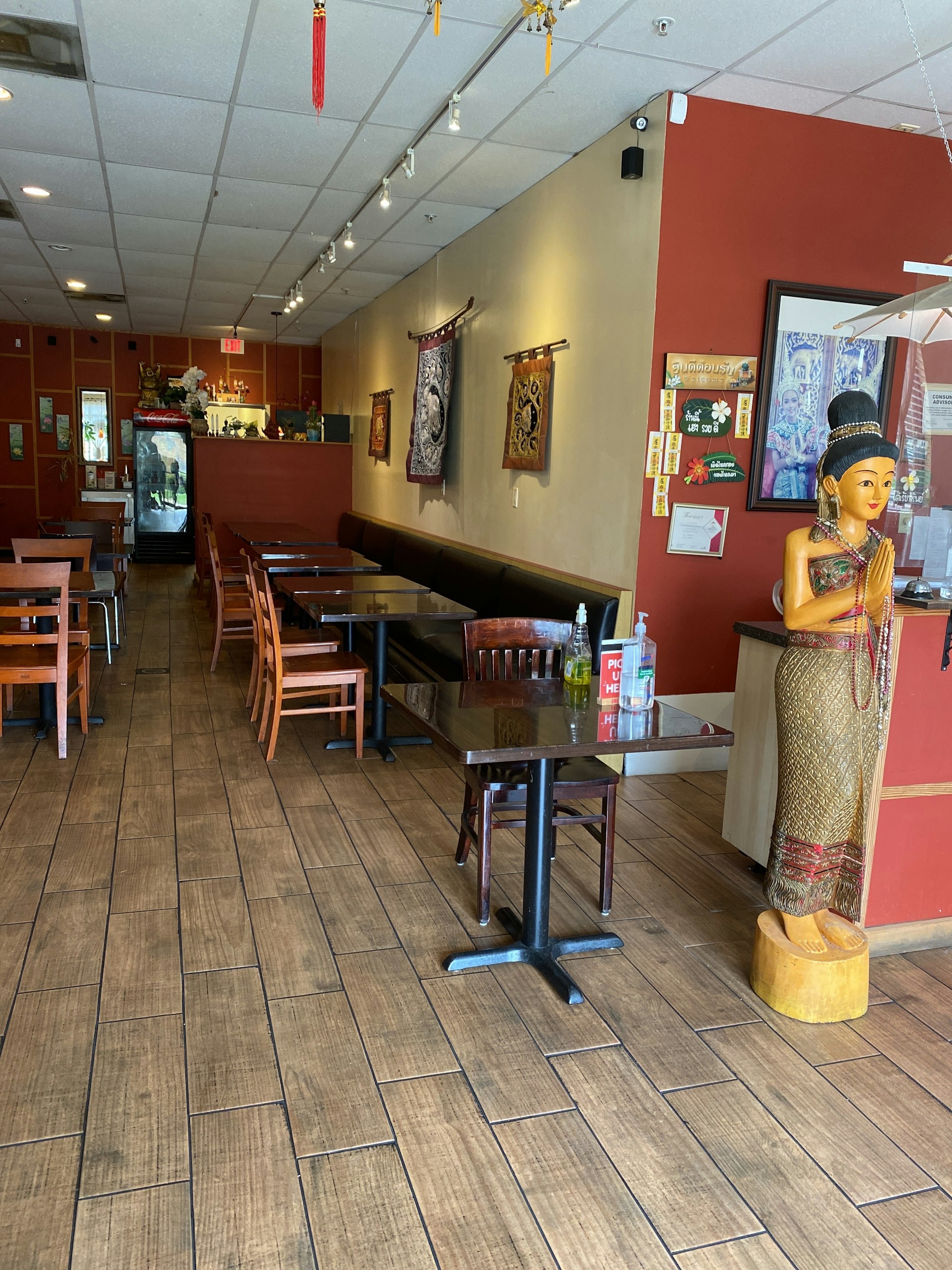 A cozy restaurant interior featuring warm lighting and cultural decorations.