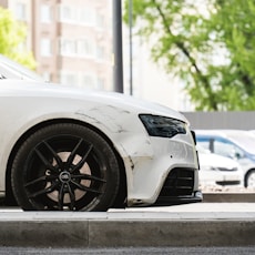 a white car parked on the side of the road