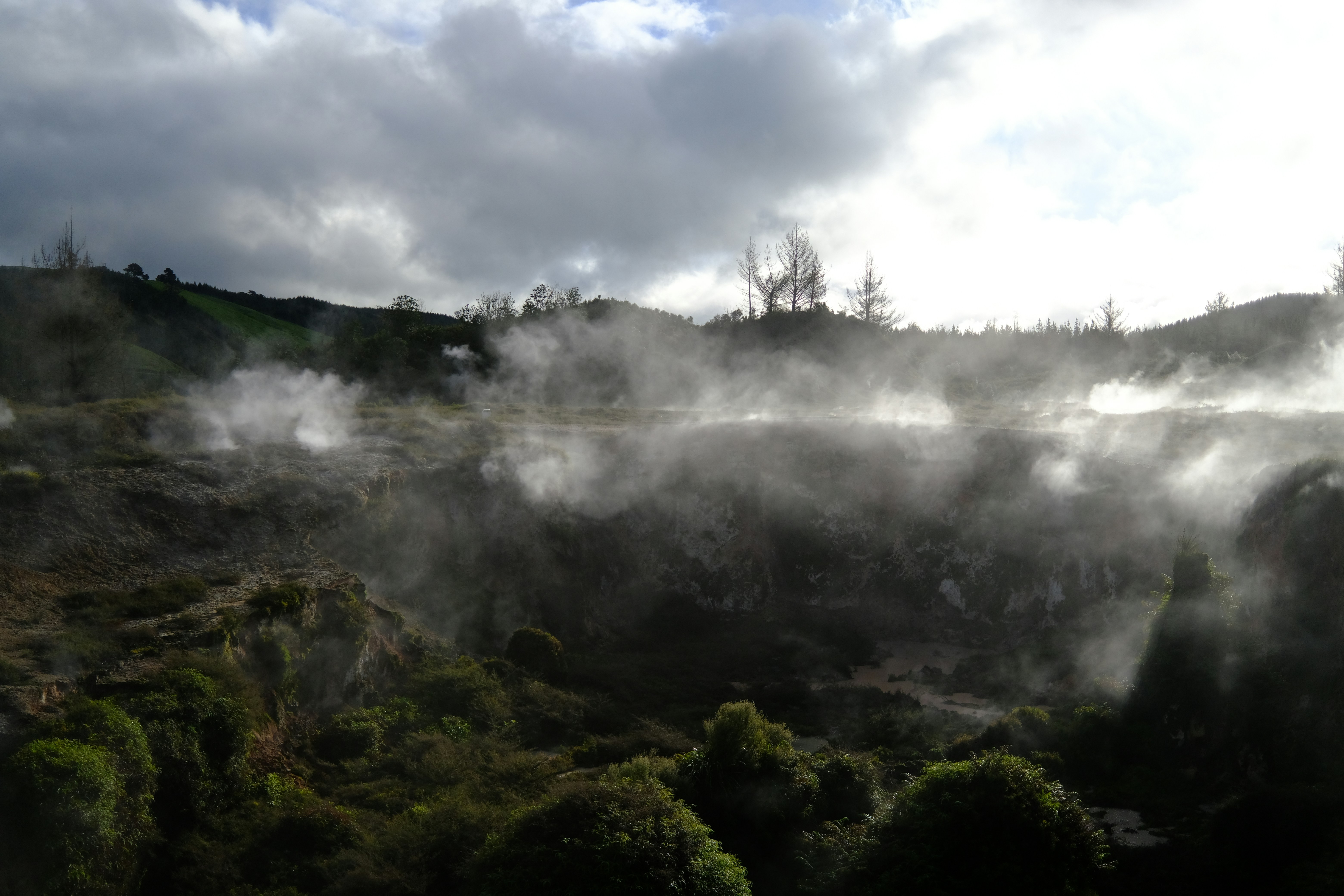 steam rises from the ground in a valley