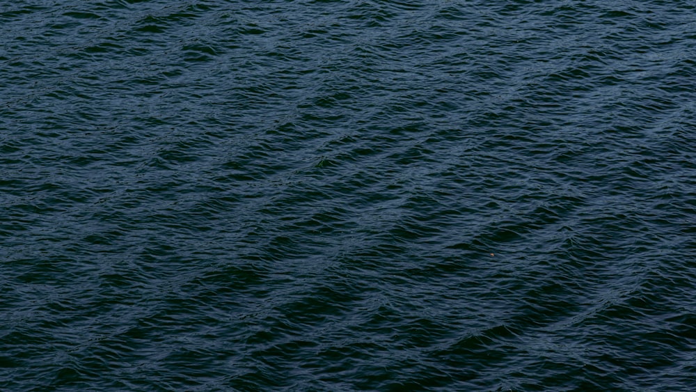 a boat floating on top of a large body of water