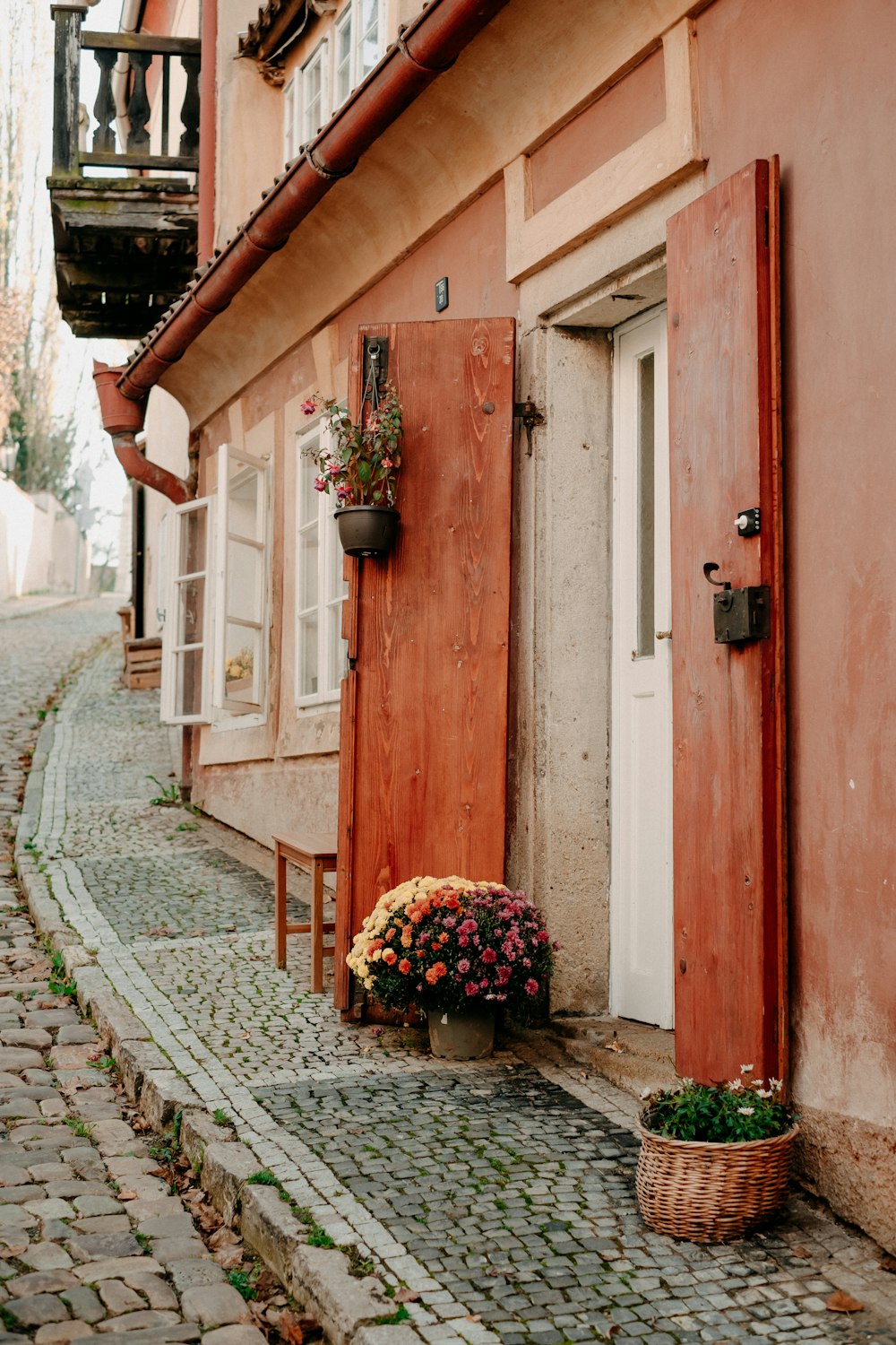 a basket of flowers sitting on the side of a building