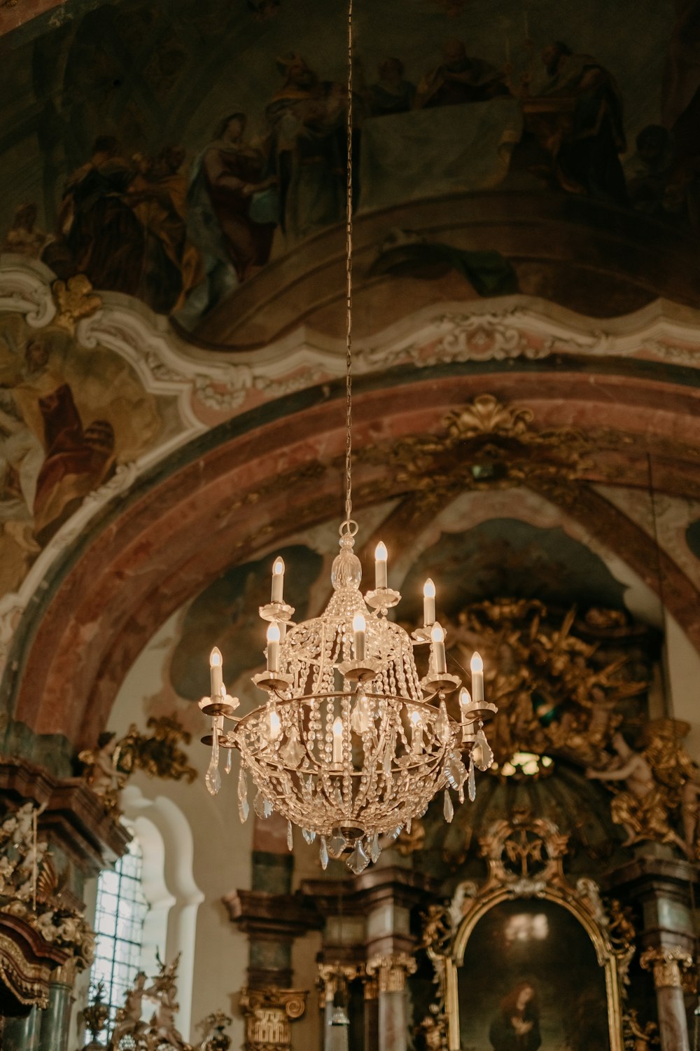 a chandelier hanging from the ceiling of a church