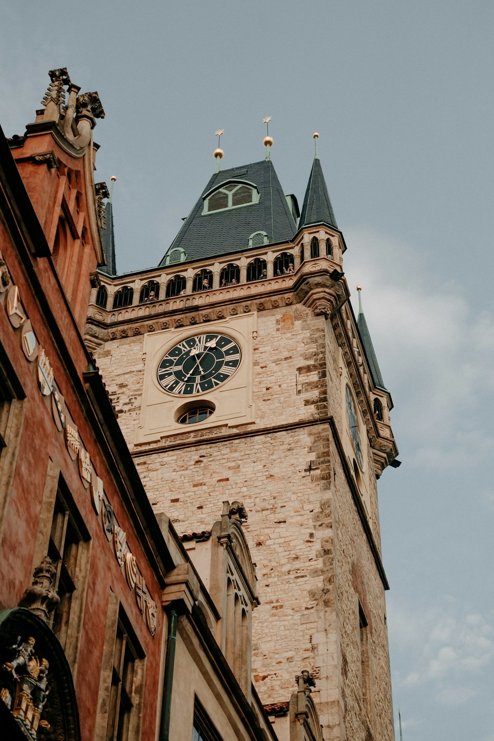 a tall brick building with a clock on it's side