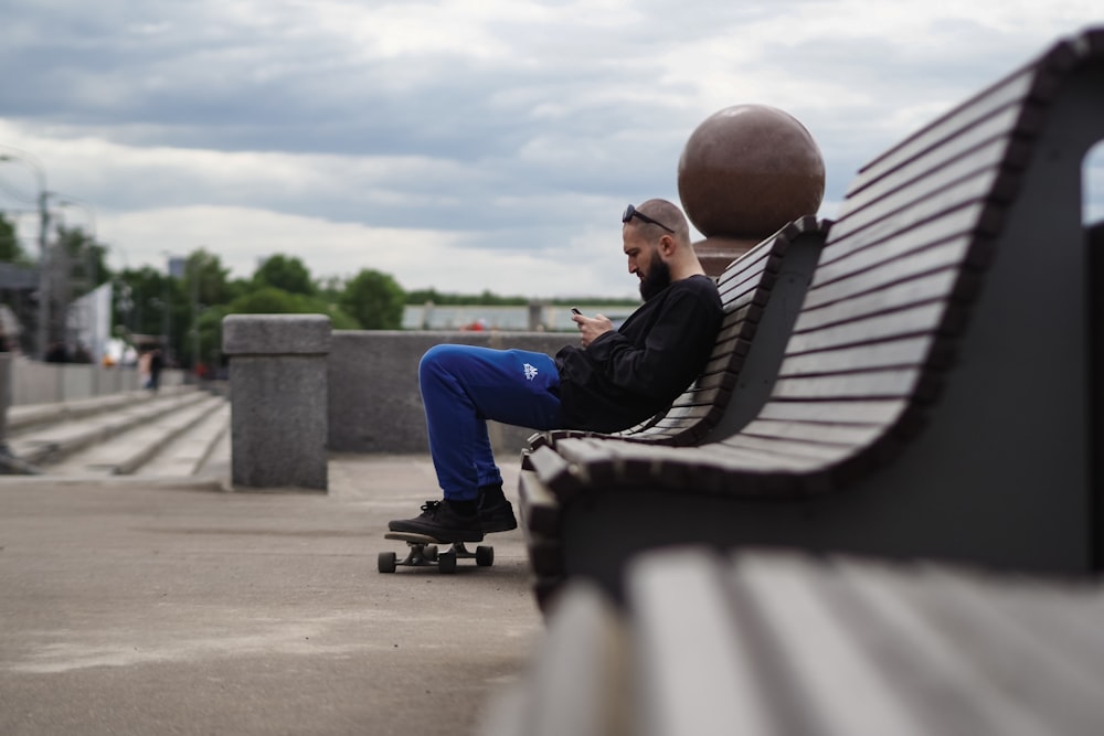 a man riding a skateboard next to a bench