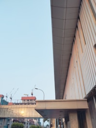 Architectural wireframe overlay on a modern construction site at dawn.