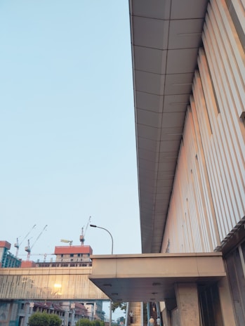 Architectural blueprint overlay on a modern housing development site at dawn.