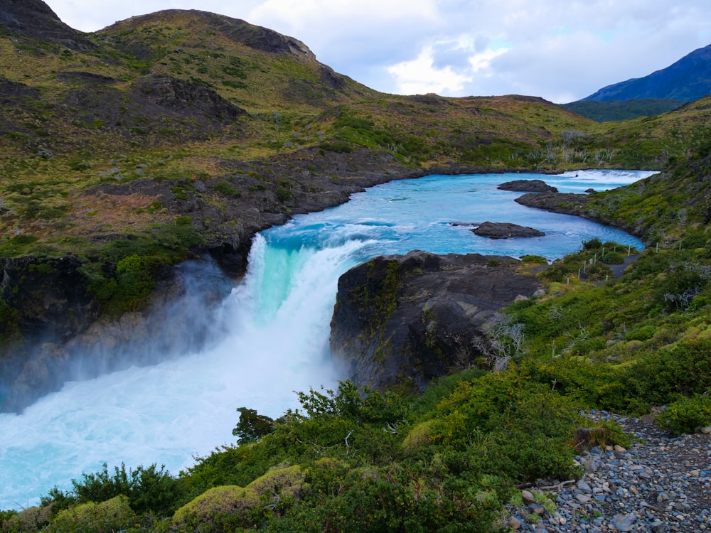 a river running through a lush green valley