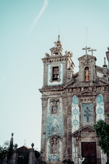 an old church with a cross on the top of it