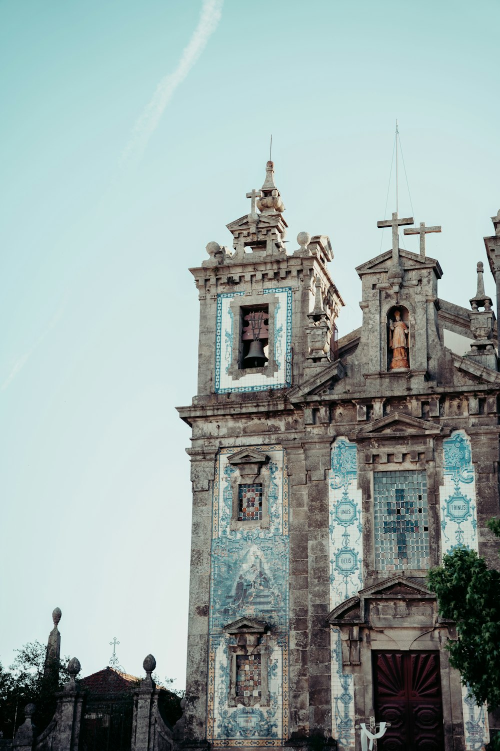 an old church with a cross on the top of it