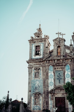 an old church with a cross on the top of it