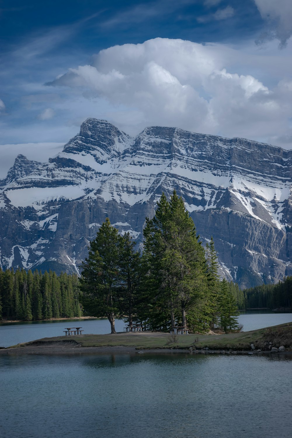 a scenic view of a mountain range with a lake in the foreground