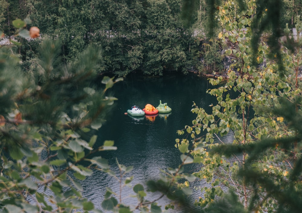 a couple of boats floating on top of a lake