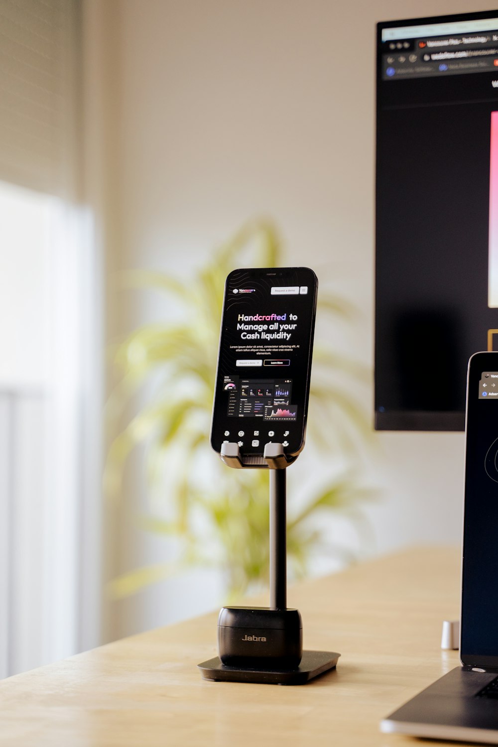 a cell phone and a laptop on a desk