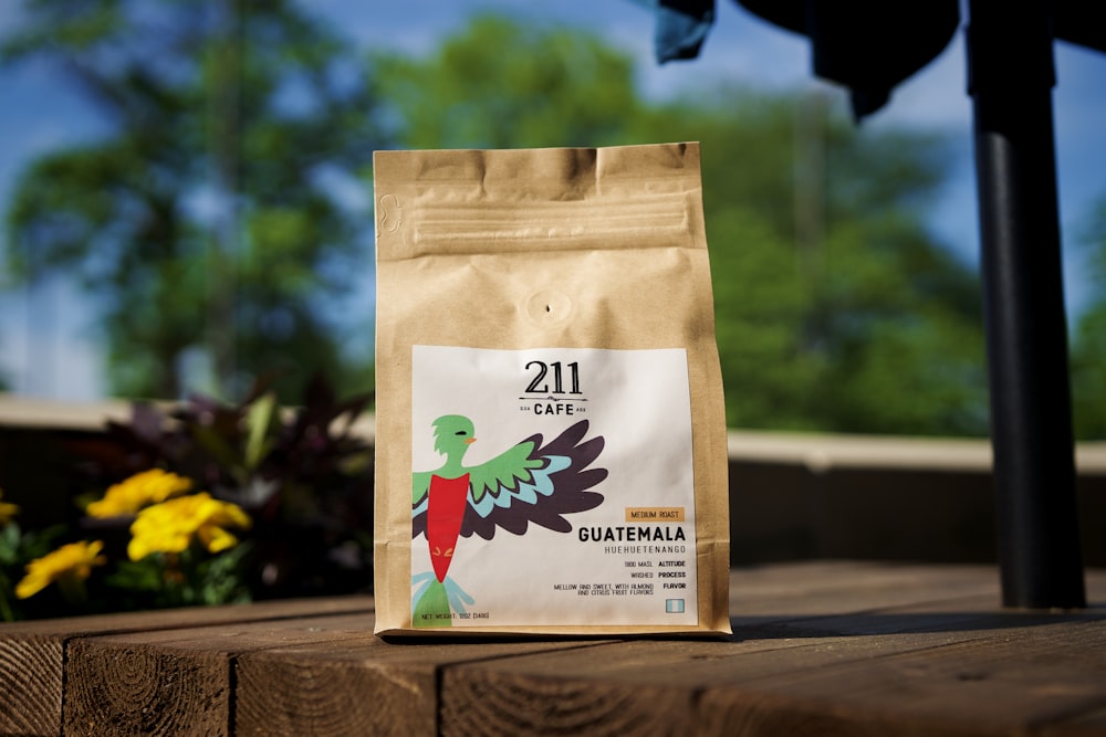 a bag of coffee sitting on top of a wooden table