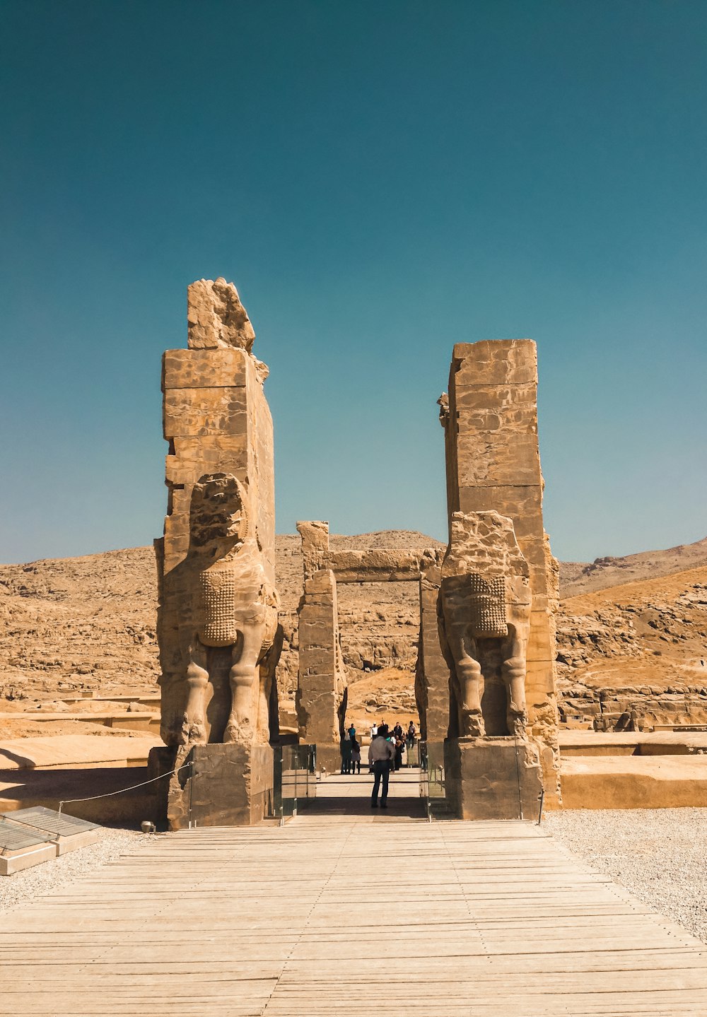 a group of people standing in front of two large statues