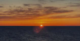 A stunning sunset over the ocean horizon.