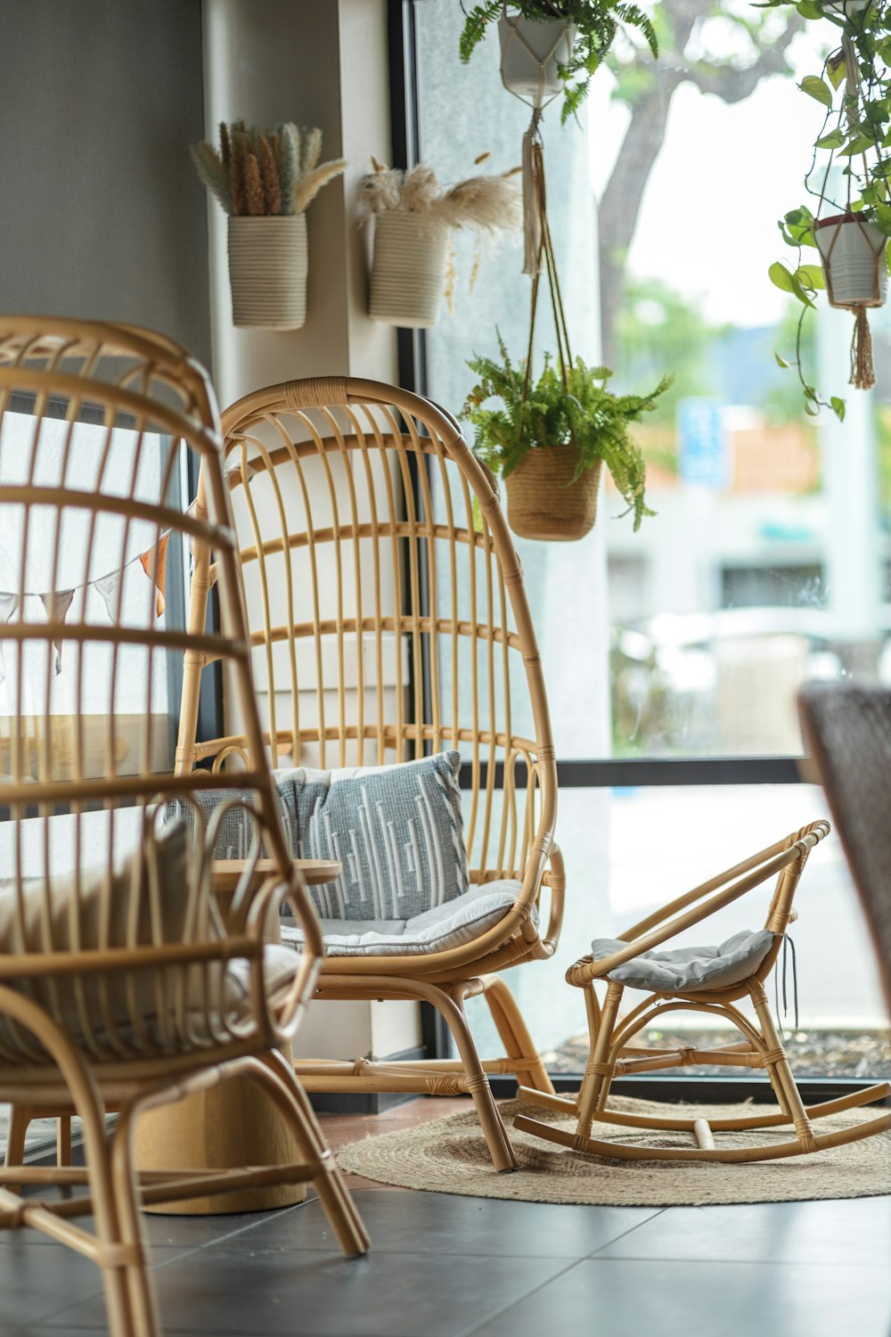 a living room with wicker furniture and potted plants