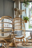 A corner of the restaurant bathed in soft light, featuring rattan chairs and lush green plants.