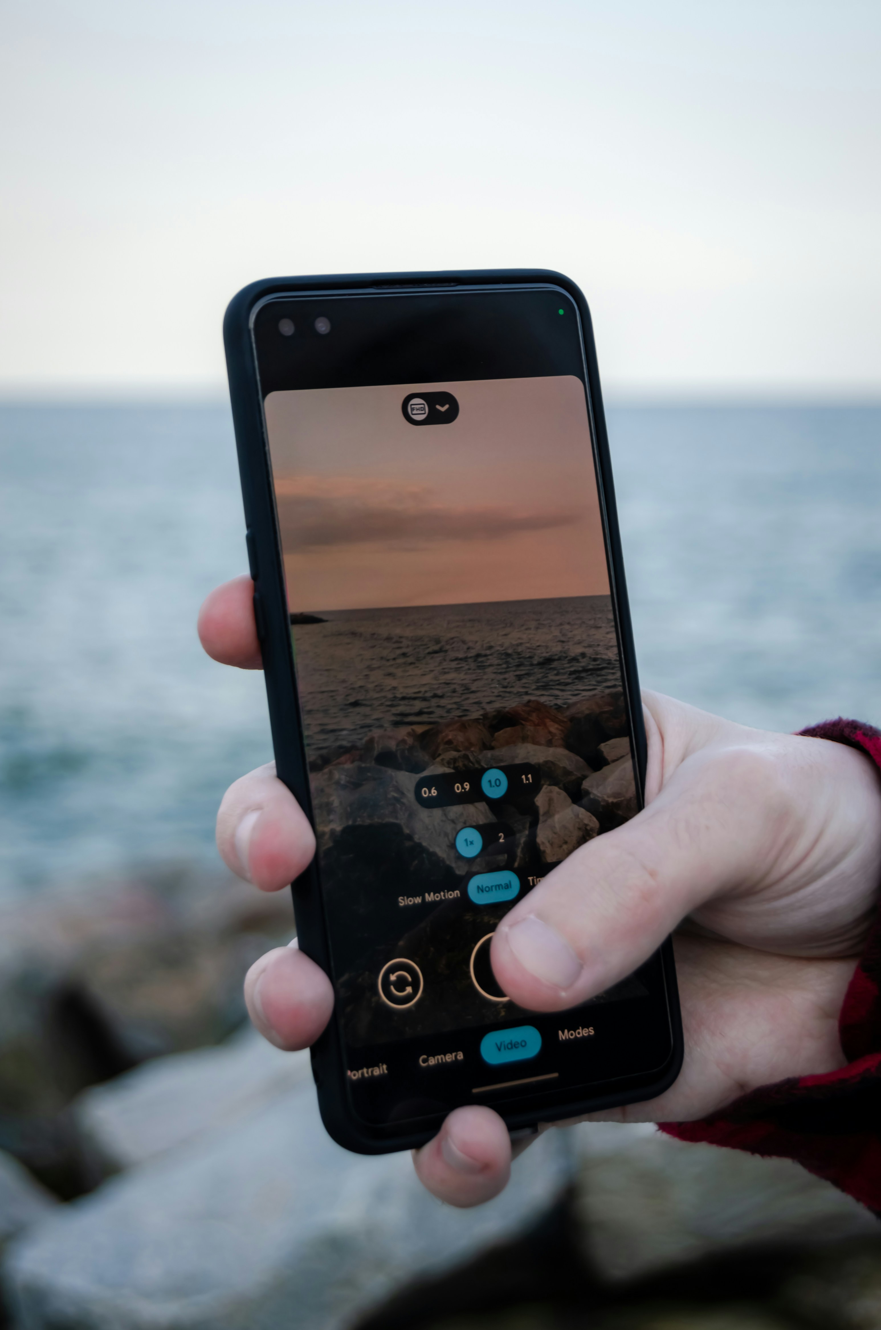 a person holding a cell phone in their hand