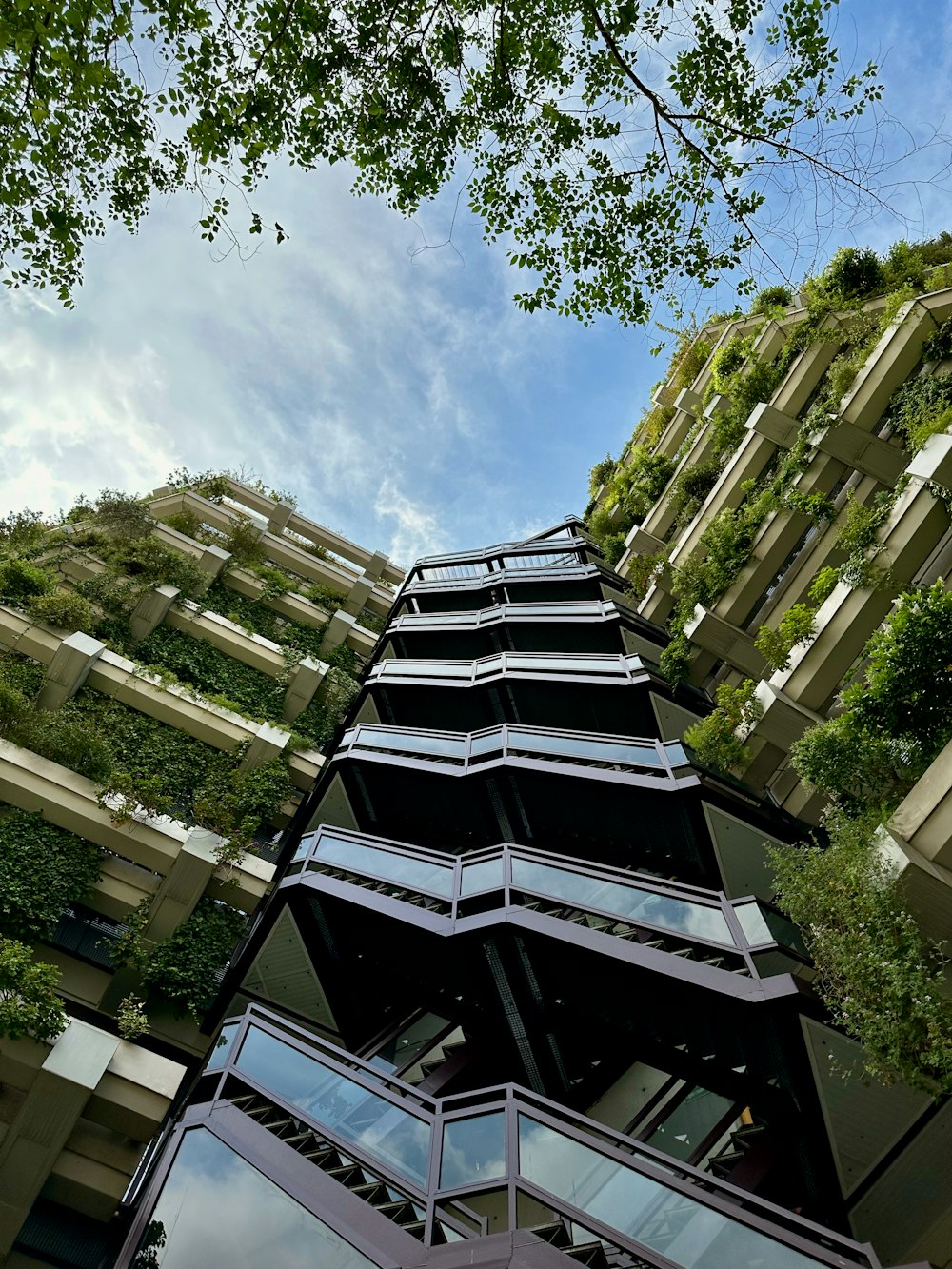 a high-rise building covered with plants