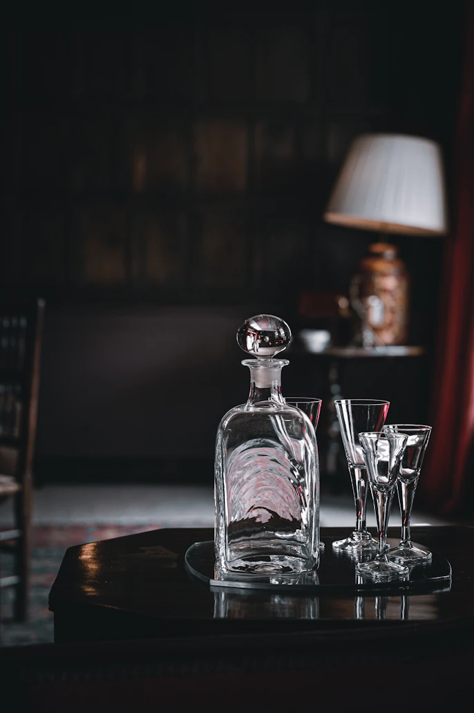An antique crystal decanter on a sideboard