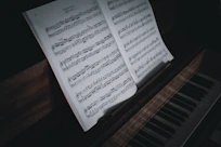 Close-up of Inna Dudukina arranging sheet music on a wooden desk.