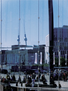 A vibrant commercial building with glass facades reflecting the bustling city street.