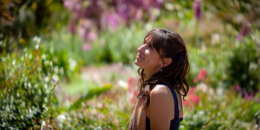 a woman standing in a field of flowers