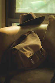A cozy wool fedora hat resting on a rustic wooden table with soft natural light.