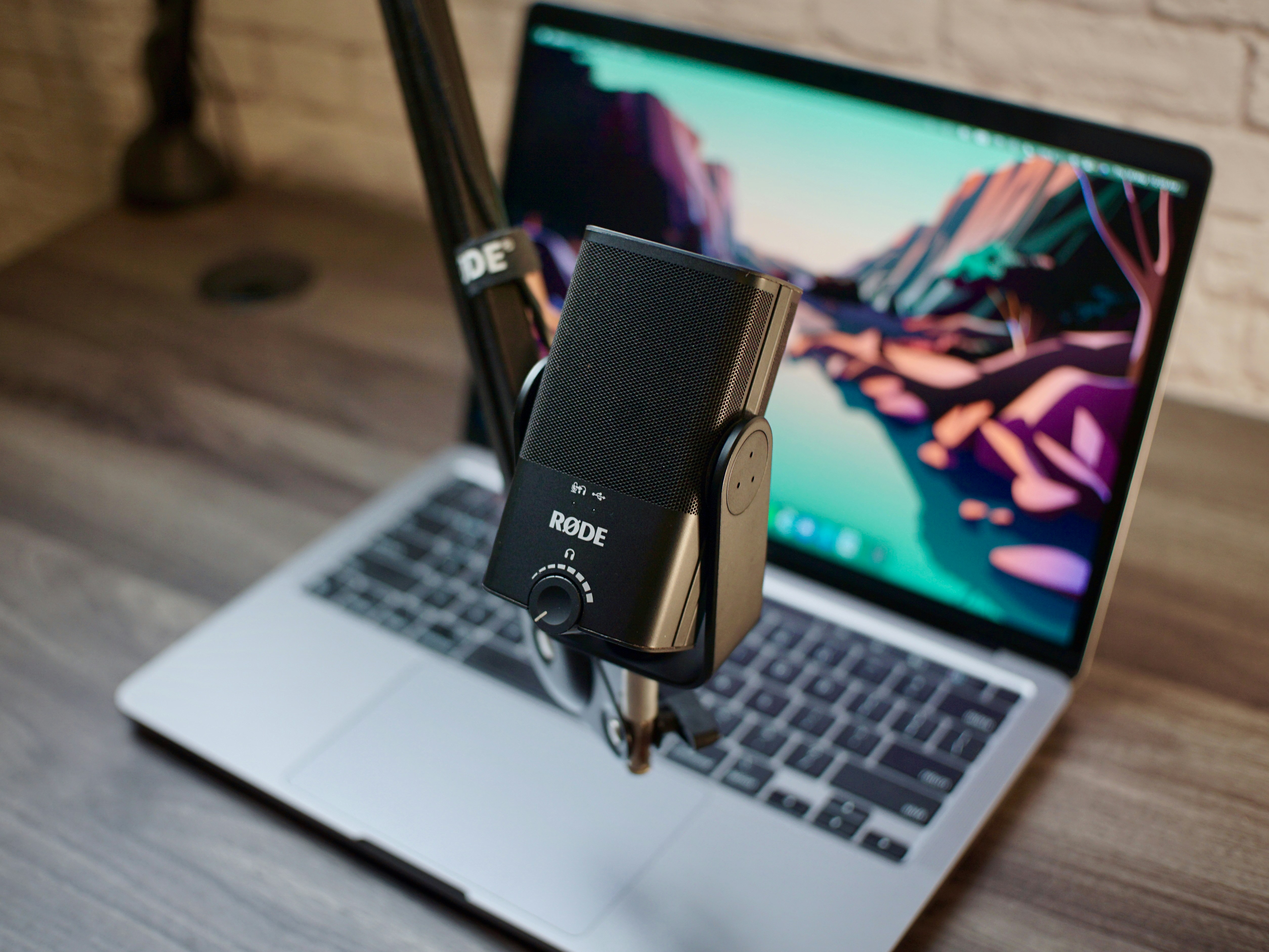 a laptop computer sitting on top of a wooden desk