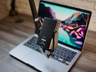 a laptop computer sitting on top of a wooden desk