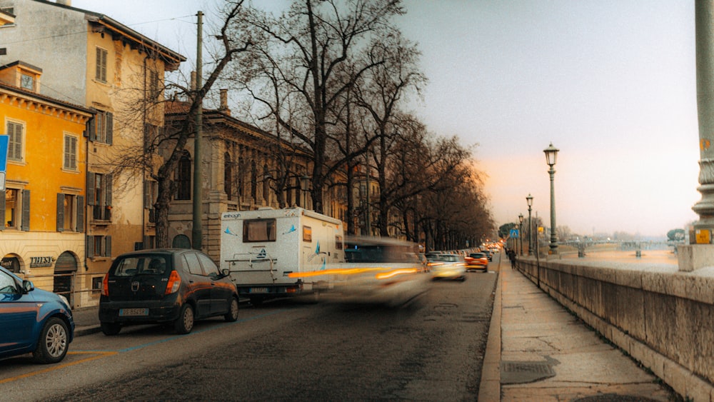 a car driving down a street next to tall buildings