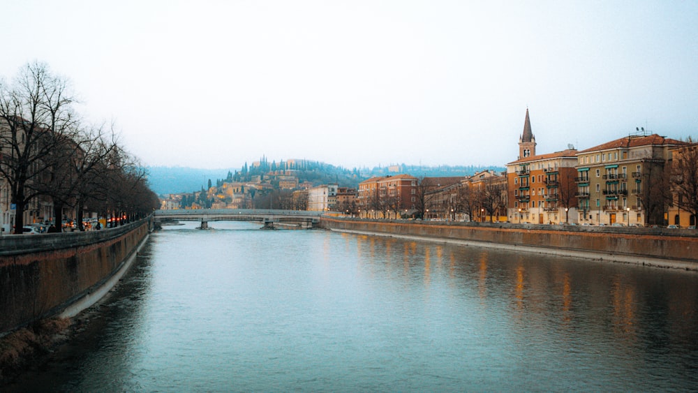 a river running through a city next to tall buildings