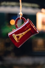 a red coffee cup hanging from a string