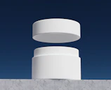 Minimalist lifestyle shot featuring a modern elegant product on a white marble surface.