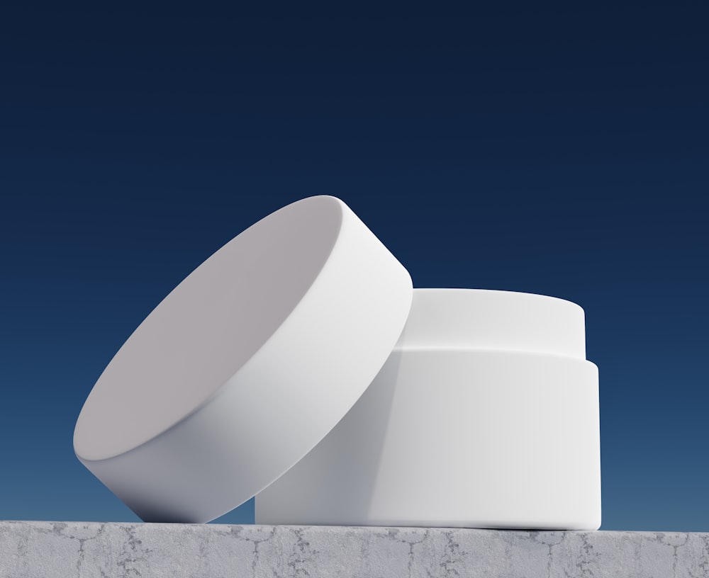 a white object sitting on top of a cement wall